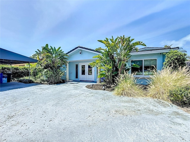 view of front of home with french doors and stucco siding