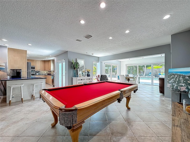 rec room with billiards table, recessed lighting, a textured ceiling, and light tile patterned flooring
