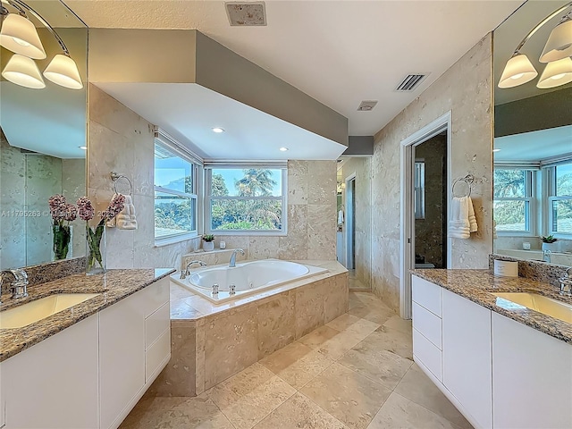 full bathroom with a garden tub and two vanities