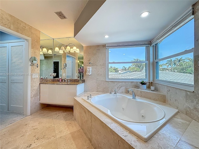 bathroom featuring a whirlpool tub and vanity