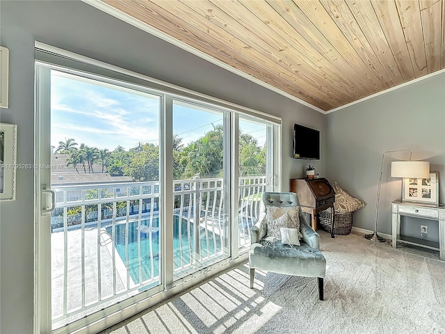 living area featuring ornamental molding, carpet flooring, wooden ceiling, and baseboards