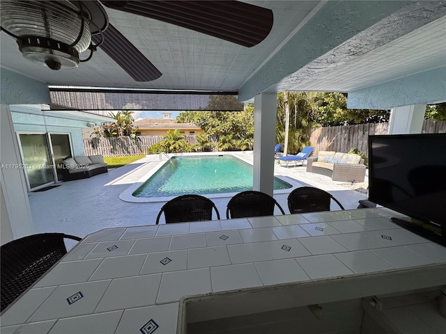 view of pool with a fenced backyard and a patio