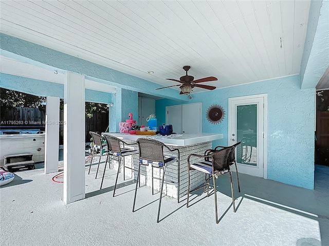 view of patio / terrace featuring fence and ceiling fan