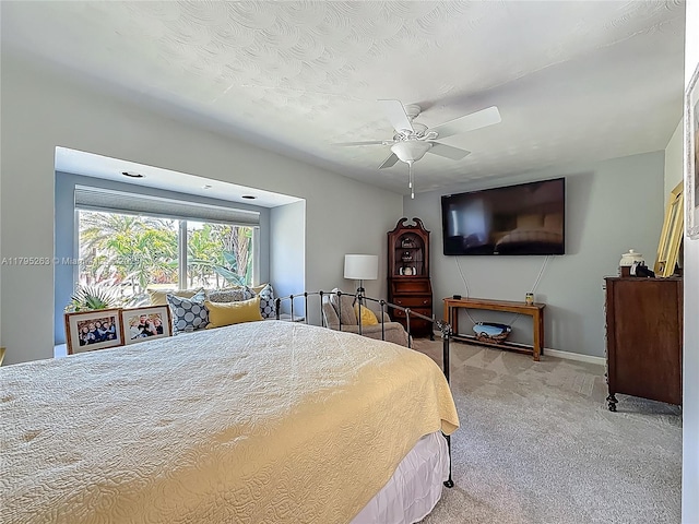 carpeted bedroom featuring ceiling fan and baseboards