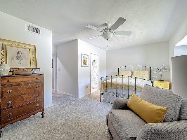 carpeted bedroom featuring baseboards and ceiling fan