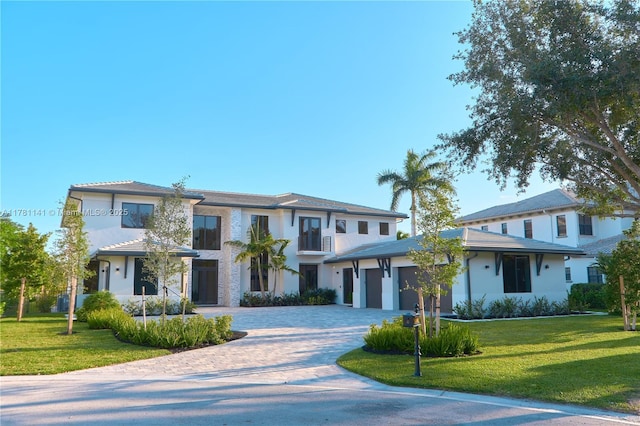 12060 NW 67th Ct, Parkland, FL 33076 - prairie-style house featuring an attached garage, stucco siding, a tile roof, and decorative driveway