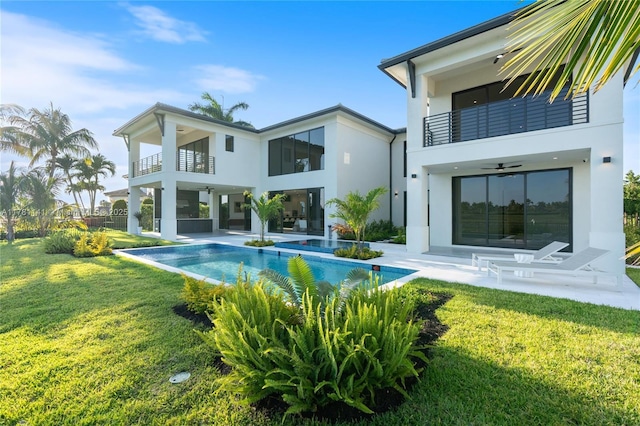 12060 NW 67th Ct, Parkland, FL 33076 - back of house with a balcony, a yard, a tiled roof, stucco siding, and a fenced backyard