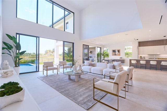 12060 NW 67th Ct, Parkland, FL 33076 - living room with recessed lighting, a towering ceiling, and stairs