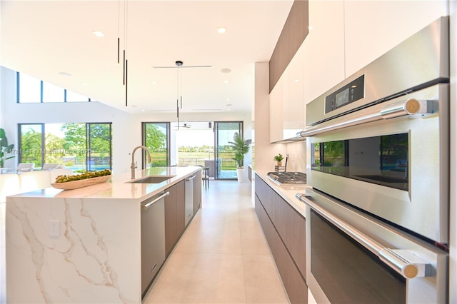 12060 NW 67th Ct, Parkland, FL 33076 - kitchen featuring modern cabinets, appliances with stainless steel finishes, and a sink