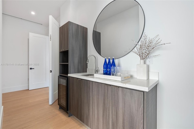 12060 NW 67th Ct, Parkland, FL 33076 - kitchen with modern cabinets, a sink, light wood-style flooring, light countertops, and recessed lighting