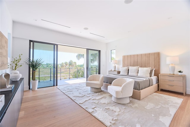 12060 NW 67th Ct, Parkland, FL 33076 - bedroom with access to outside, multiple windows, and light wood-style floors