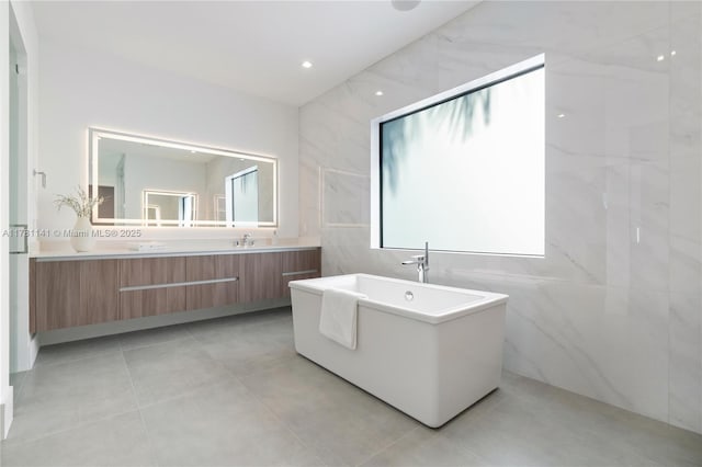 12060 NW 67th Ct, Parkland, FL 33076 - full bath featuring a sink, double vanity, tile walls, and a freestanding bath