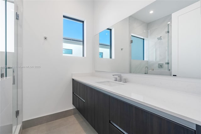 12060 NW 67th Ct, Parkland, FL 33076 - bathroom featuring tile patterned flooring, baseboards, a shower stall, and vanity