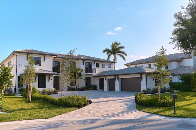 12060 NW 67th Ct, Parkland, FL 33076 - prairie-style house with decorative driveway, a garage, a front yard, and stucco siding