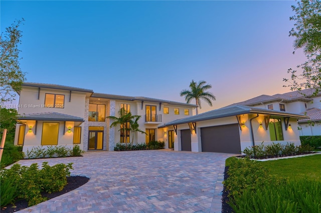 12060 NW 67th Ct, Parkland, FL 33076 - prairie-style home with decorative driveway, an attached garage, and stucco siding