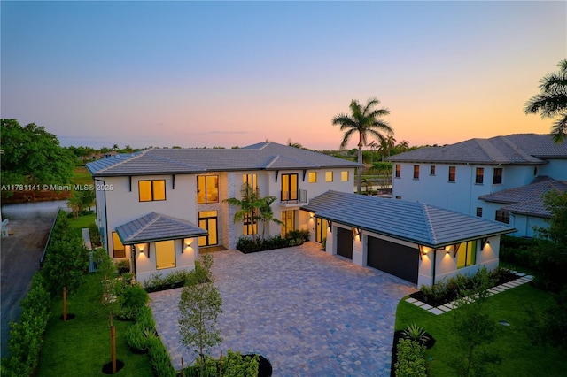 12060 NW 67th Ct, Parkland, FL 33076 - view of front of house featuring an attached garage, decorative driveway, a tile roof, and a front lawn