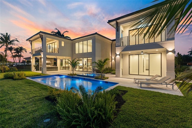 12060 NW 67th Ct, Parkland, FL 33076 - back of house featuring a yard, a patio, stucco siding, and a balcony