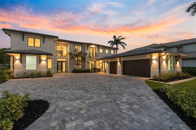 12060 NW 67th Ct, Parkland, FL 33076 - prairie-style home with a tile roof, stucco siding, a garage, and decorative driveway