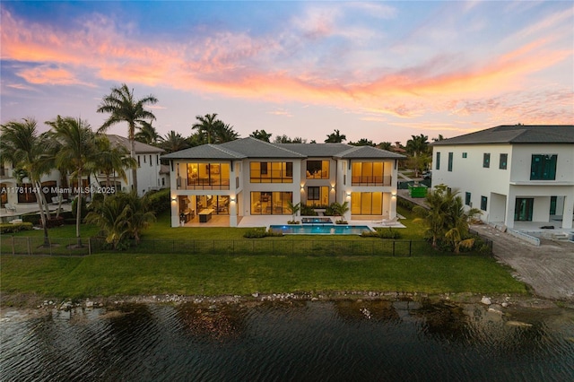 12060 NW 67th Ct, Parkland, FL 33076 - back of property featuring a patio, a water view, a fenced backyard, and a balcony
