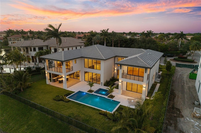12060 NW 67th Ct, Parkland, FL 33076 - back of house with a balcony, a yard, a tiled roof, stucco siding, and a fenced backyard
