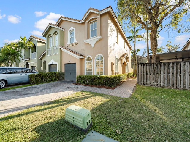1416 SE 26th Ave, Homestead, FL 33035 - view of front facade with a tile roof, decorative driveway, fence, an attached garage, and stucco siding