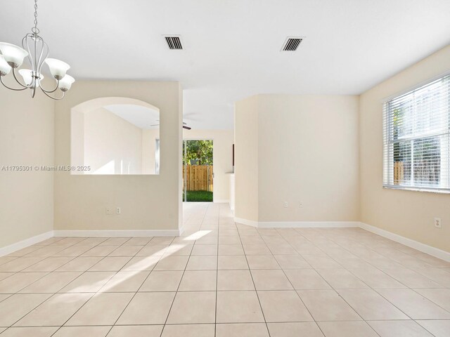 1416 SE 26th Ave, Homestead, FL 33035 - spare room with visible vents, baseboards, light tile patterned floors, and an inviting chandelier