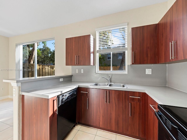 1416 SE 26th Ave, Homestead, FL 33035 - kitchen with light tile patterned floors, light countertops, black appliances, and a peninsula