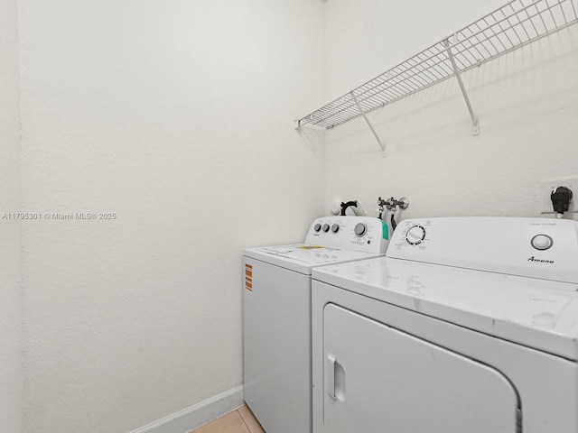 1416 SE 26th Ave, Homestead, FL 33035 - laundry room featuring washer and dryer, light tile patterned floors, laundry area, and baseboards