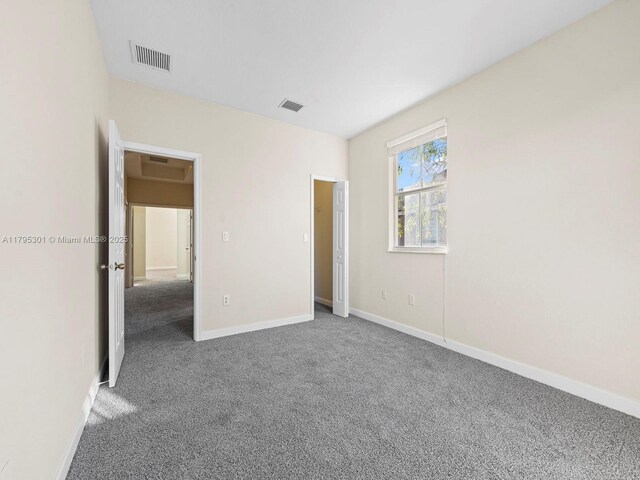 1416 SE 26th Ave, Homestead, FL 33035 - unfurnished bedroom with baseboards, visible vents, and carpet