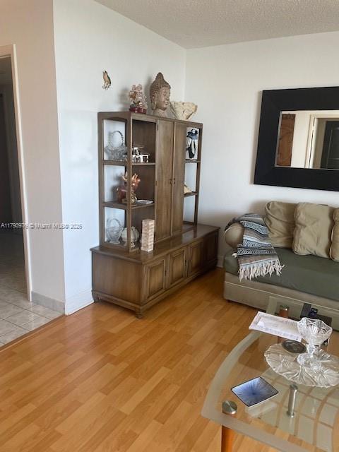 2750 NE 183rd St Unit 2604, Aventura, FL 33160 - living area with a textured ceiling and light wood finished floors