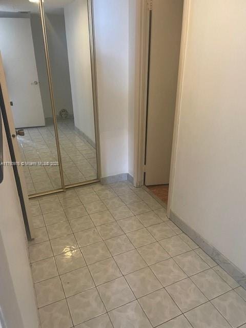 2750 NE 183rd St Unit 2604, Aventura, FL 33160 - unfurnished bedroom with a closet, baseboards, and light tile patterned flooring