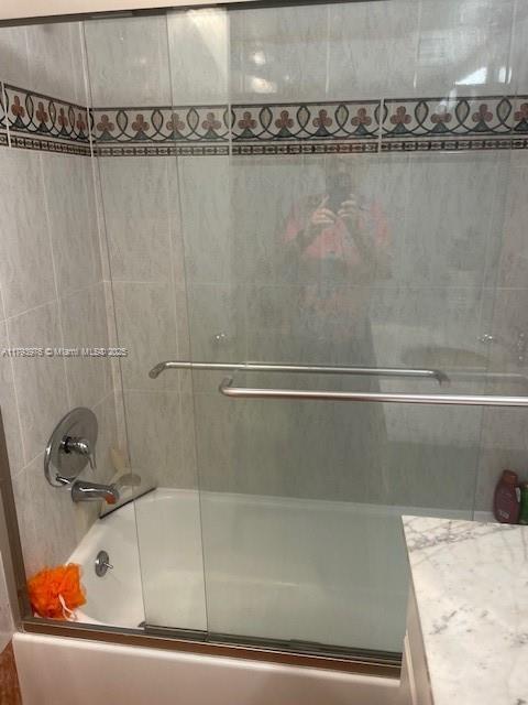 2750 NE 183rd St Unit 2604, Aventura, FL 33160 - bathroom featuring vanity and shower / bath combination with glass door
