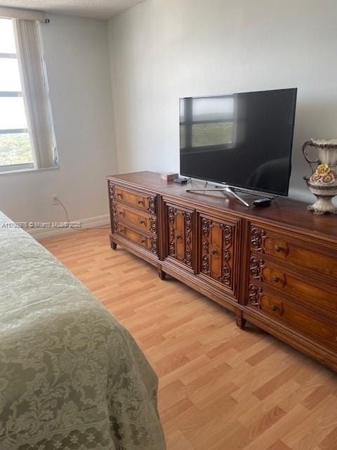 2750 NE 183rd St Unit 2604, Aventura, FL 33160 - bedroom with baseboards and light wood-style flooring