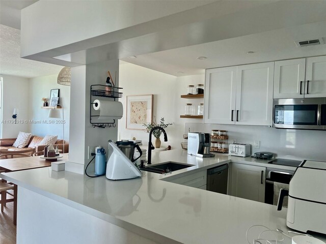 2101 Brickell Ave Unit 3208, Miami, FL 33129 - kitchen with a sink, light countertops, stainless steel microwave, and dishwasher