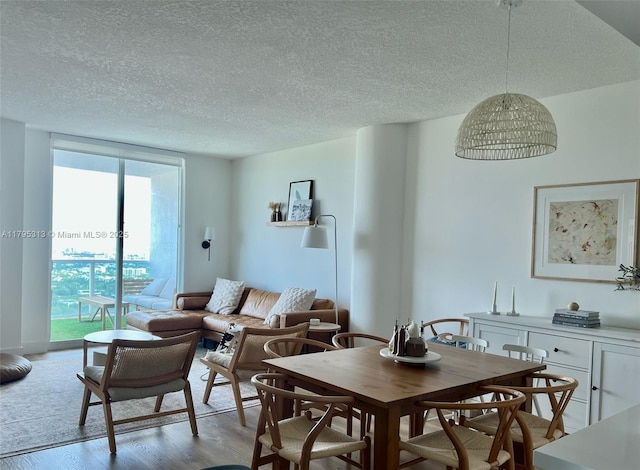 2101 Brickell Ave Unit 3208, Miami, FL 33129 - dining area with light wood-style flooring and a textured ceiling