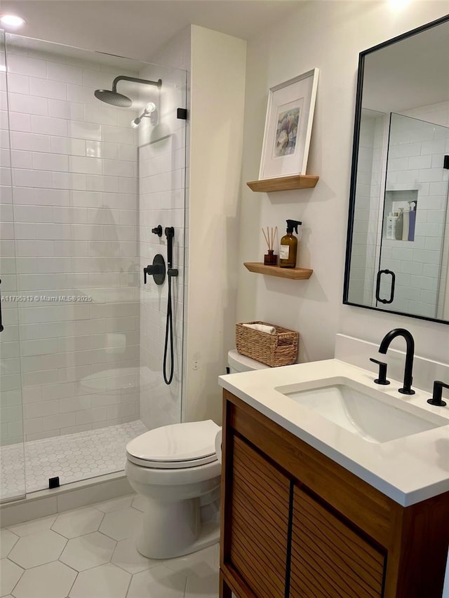 2101 Brickell Ave Unit 3208, Miami, FL 33129 - full bath featuring vanity, tile patterned flooring, a stall shower, and toilet