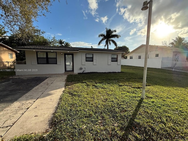 1770 NW 109th St, Miami, FL 33167 - view of front of property with fence, stucco siding, and a front lawn