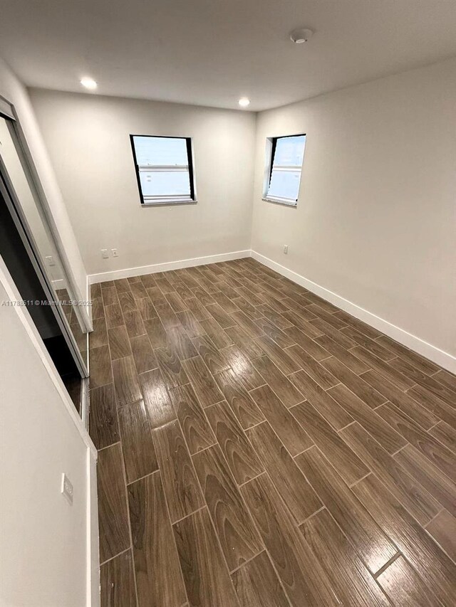 1770 NW 109th St, Miami, FL 33167 - empty room with recessed lighting, baseboards, and dark wood-type flooring