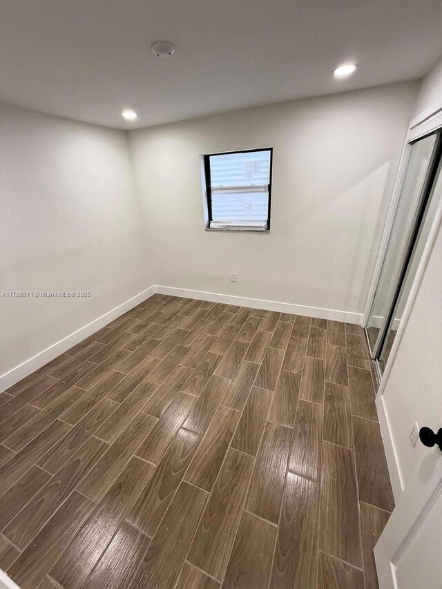 1770 NW 109th St, Miami, FL 33167 - spare room featuring wood tiled floor, baseboards, and recessed lighting