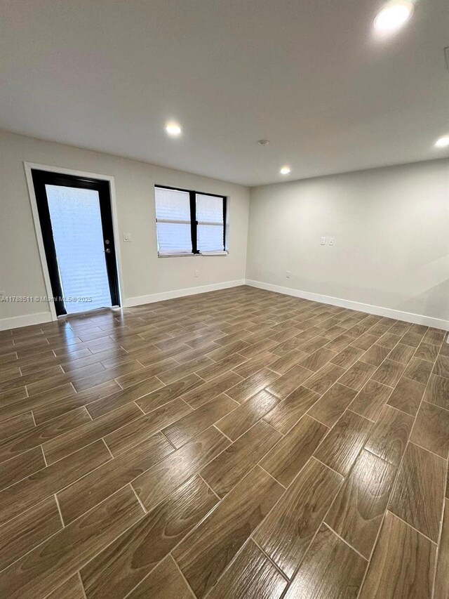 1770 NW 109th St, Miami, FL 33167 - empty room with wood tiled floor, baseboards, and recessed lighting