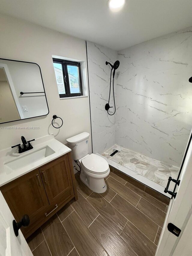 1770 NW 109th St, Miami, FL 33167 - bathroom featuring vanity, wood tiled floor, toilet, and a shower stall