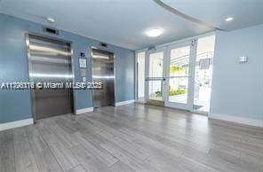 empty room with baseboards and wood finished floors
