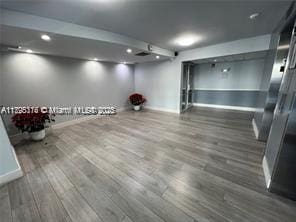 finished basement featuring baseboards, recessed lighting, and wood finished floors