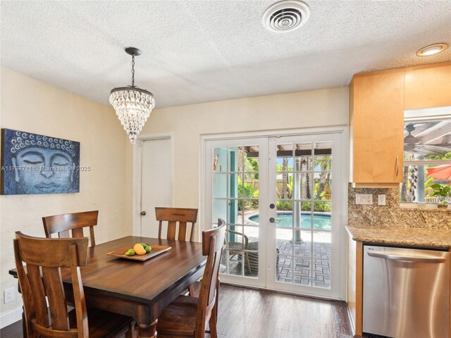 4400 NE 13th Ave, Oakland Park, FL 33334 - dining room with a textured ceiling, french doors, plenty of natural light, and wood finished floors