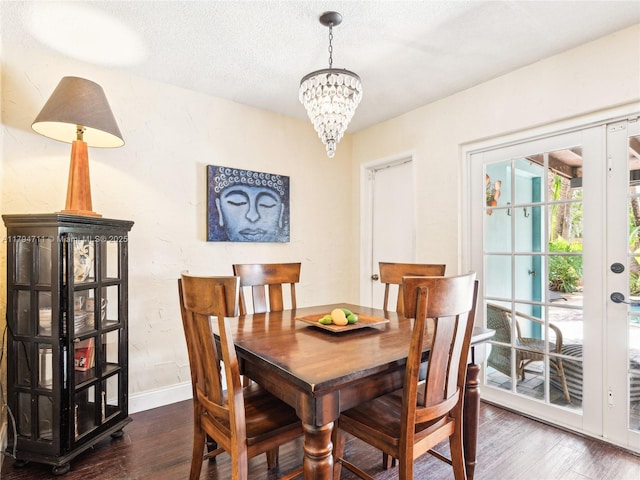 4400 NE 13th Ave, Oakland Park, FL 33334 - dining area with a textured ceiling, wood finished floors, baseboards, and a notable chandelier