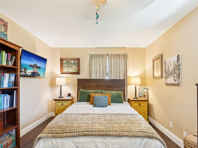 4400 NE 13th Ave, Oakland Park, FL 33334 - bedroom featuring baseboards and dark wood-style floors