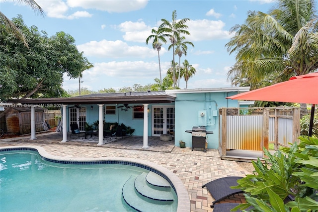4400 NE 13th Ave, Oakland Park, FL 33334 - view of pool featuring area for grilling, ceiling fan, french doors, fence, and a patio