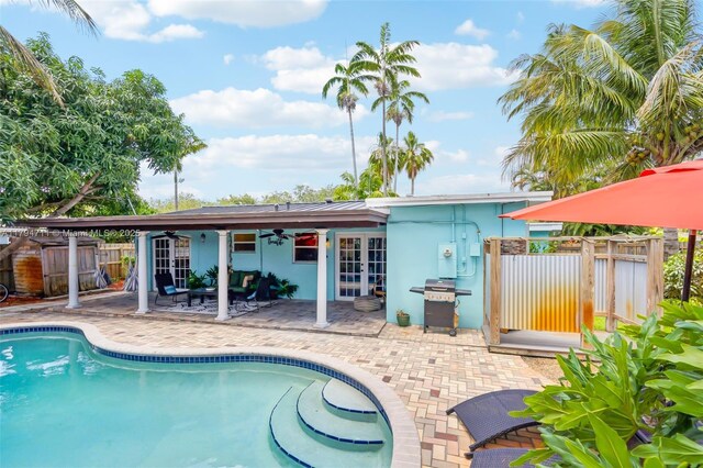 4400 NE 13th Ave, Oakland Park, FL 33334 - view of pool with fence, grilling area, a patio, french doors, and a ceiling fan