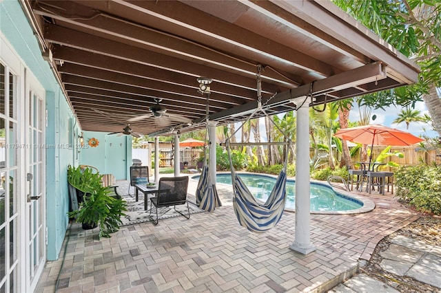 4400 NE 13th Ave, Oakland Park, FL 33334 - view of patio / terrace with a fenced backyard, a ceiling fan, french doors, and an outdoor pool