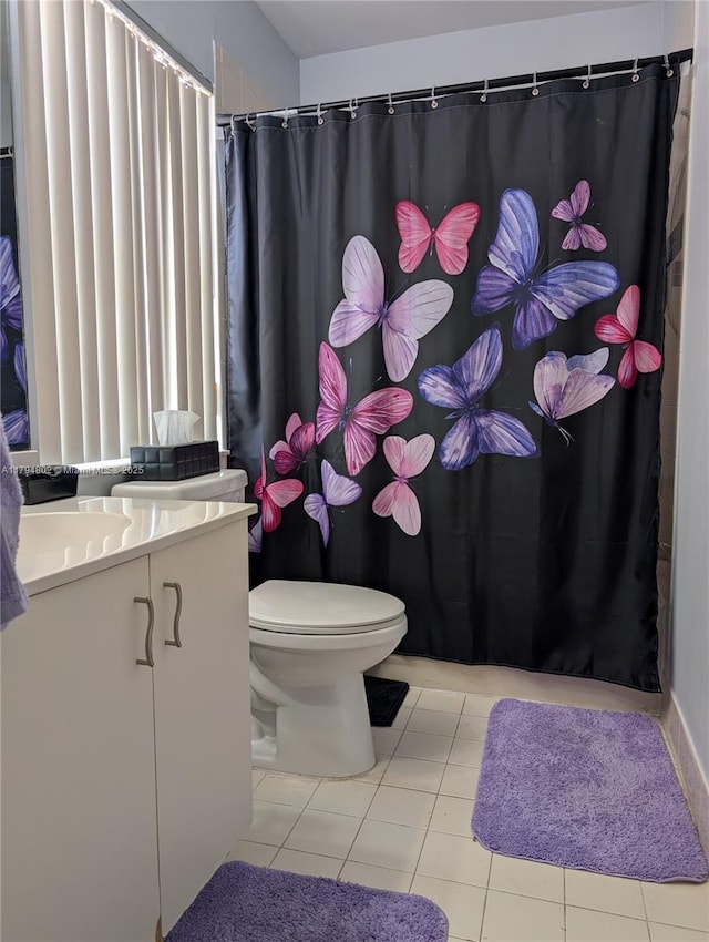 bathroom with toilet, tile patterned floors, a shower with curtain, and vanity